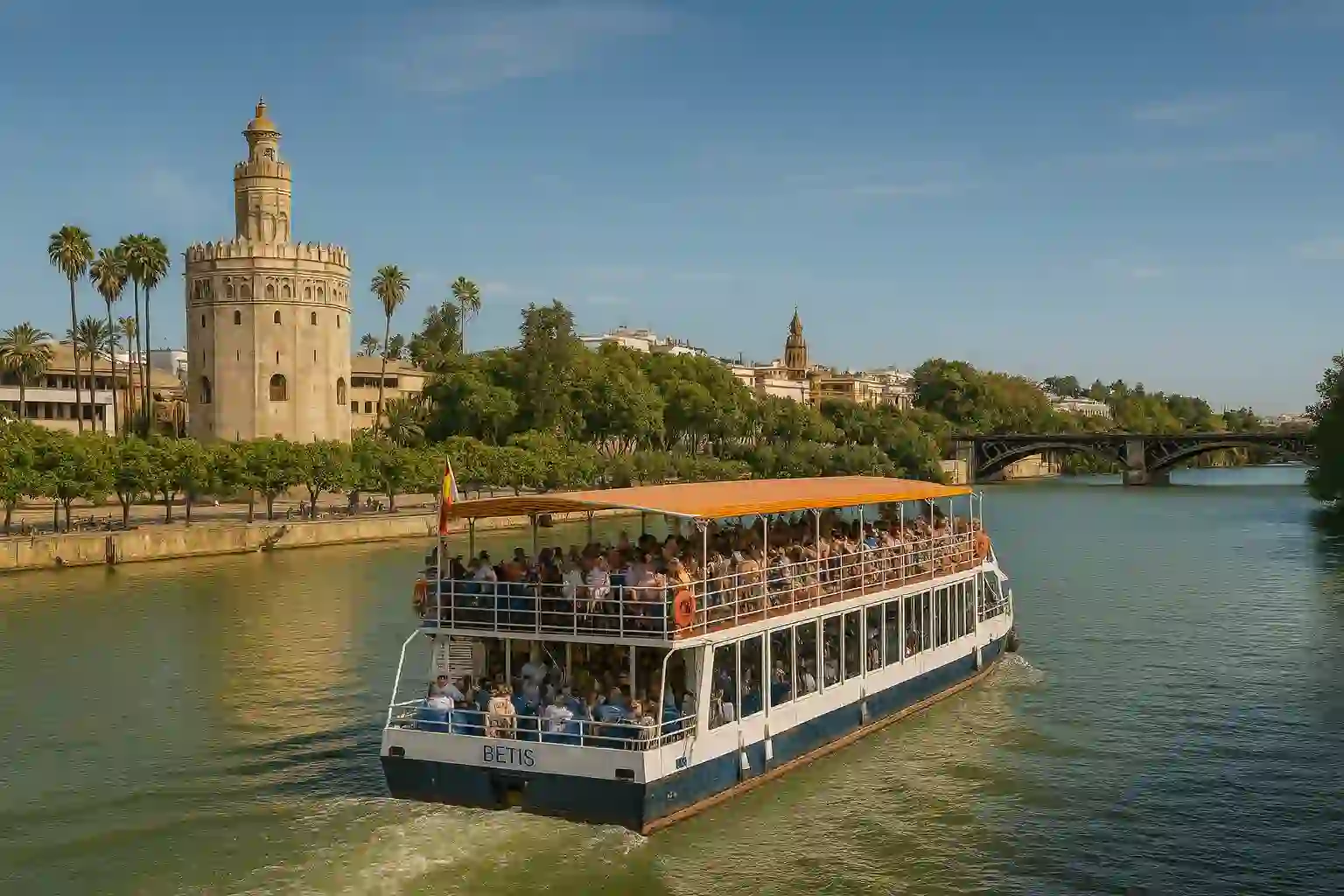 Eco-cruise boat sailing along Guadalquivir River with Seville landmarks in background